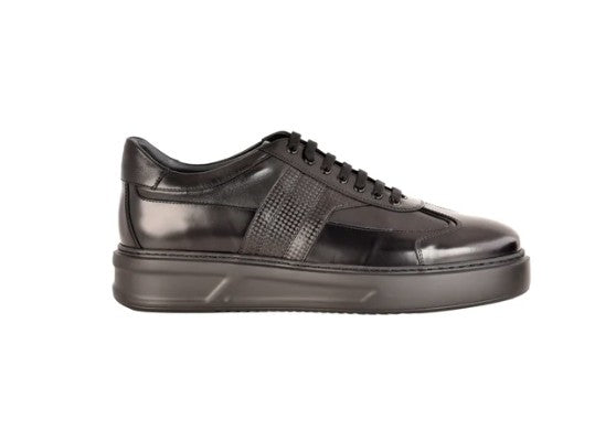 A black leather low-top sneaker with a textured side panel, black laces, and a black sole, shown in profile against a plain white background.