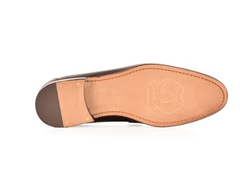 The sole side of a brown leather shoe, showing the tan insole with an embossed logo and a dark brown heel cap, on a white background.
