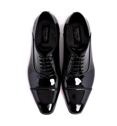 A pair of glossy black patent leather cap-toe oxford shoes with lace-up fronts, shown from a top-down view on a white background. The brand name 'CORRENTE' is visible on the insole.