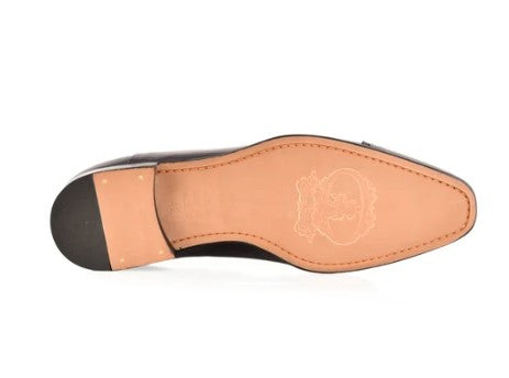 The underside of a black leather dress shoe showing the tan insole with logo and a black heel cap, on a white background.