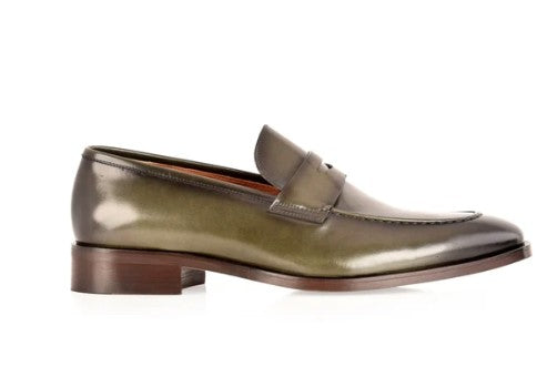 A single men's penny loafer in metallic green leather, shown in a side profile against a plain white background.