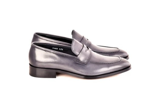 A pair of men's penny loafers in a dark gray leather, shown from a side profile view against a plain white background.