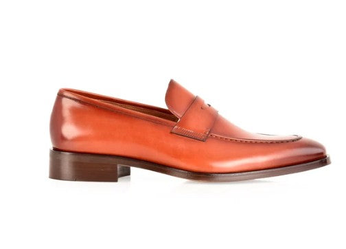 A single men's penny loafer in smooth tan leather, shown in a side profile on a clean white background.