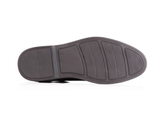 The dark brown rubber outsole of a shoe, showing its tread pattern, photographed on a white background.