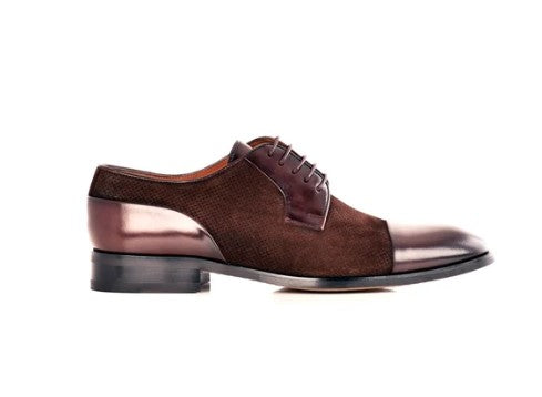 A brown leather lace-up dress shoe with a textured grain pattern, glossy cap toe, and black sole, shown in profile against a white background.
