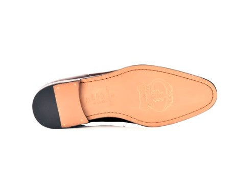 Top-down view of a men's dress shoe showing the tan leather insole, black heel cap, and white side edge against a white background.