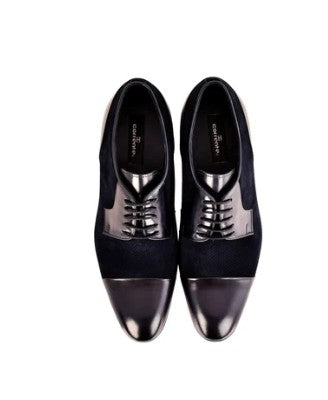A pair of men's dress shoes featuring a black suede upper and a glossy black leather cap toe, with matching black laces, shown from a top-down view on a white background.