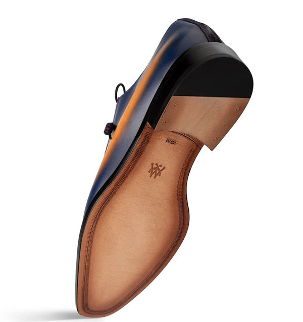 A single men's dress shoe shown from the sole angle, featuring a black heel, and a tan leather insole with a monogram logo.