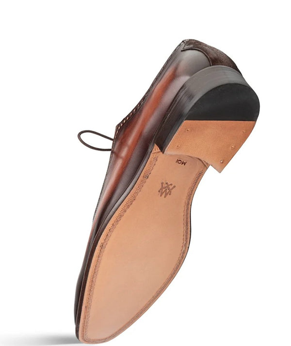 A single brown leather dress shoe shown from a side angle, displaying a black rubber heel cap, tan insole, and a small logo on the bottom.