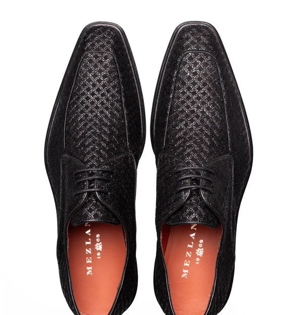 A pair of black textured leather dress shoes with a woven pattern on the toe and upper, shown from a top-down view on a white background. The interior lining is orange, and the brand name 'MEZLAN' is visible on the insole.