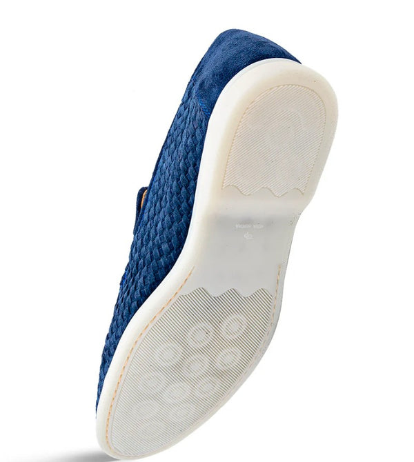 A single blue slip-on shoe shown from the sole side photographed on a clean white background.