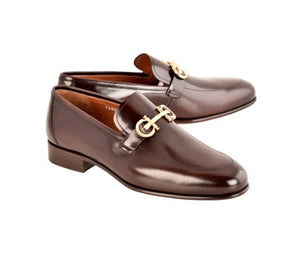 A pair of dark brown leather penny loafers with silver horsebit hardware, displayed on a clean white background.