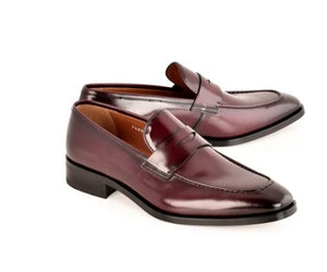 A pair of men's penny loafers in glossy dark burgundy leather, displayed on a clean white background.