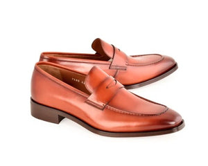 A pair of men's penny loafers in smooth brown leather, displayed on a clean white background.