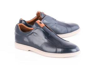 A pair of men's slip-on loafers in dark navy blue leather with a contrasting tan pull tab, shown on a white background.