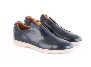 A pair of men's slip-on loafers in glossy navy blue leather with tan accents, set against a plain white background.