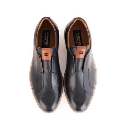 A pair of black leather slip-on dress shoes with tan accents and a black brand label visible inside, shown from a top-down view on a white background.