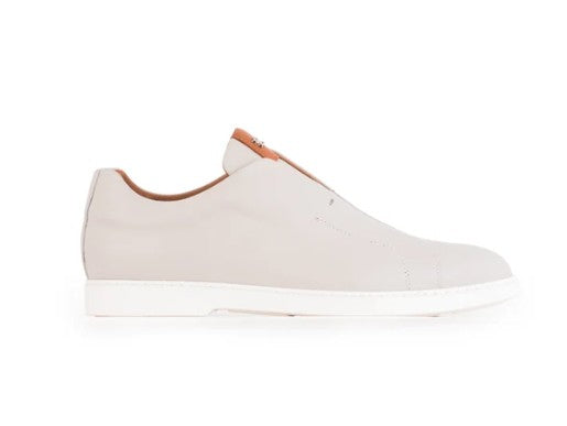 Single slip-on casual shoe in light beige leather with a contrasting brown leather shown on a white background.