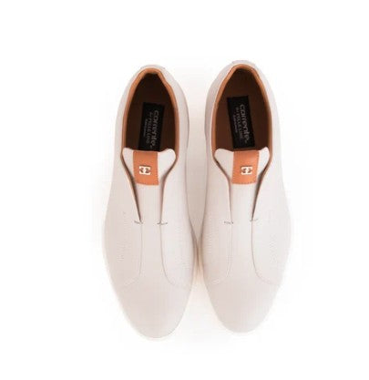 A pair of slip-on loafers in light cream, shown from a top-down view on a white background. 
