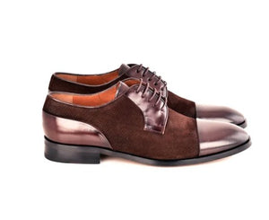 A pair of men's brown oxford shoes with a mix of textured suede and glossy patent leather panels, shown from a side profile on a white background.