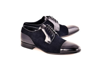 A pair of men's black cap-toe oxford shoes with a mix of suede and leather materials, shown on a plain white background.