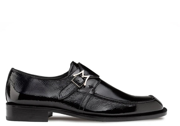 A single black leather dress shoe with a glossy finish, featuring a decorative strap with a silver-tone buckle on the instep, set against a plain white background.