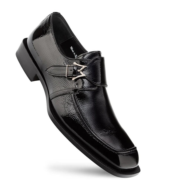 A single black leather dress shoe with a unique strap design featuring a silver-tone buckle and decorative metal details, shown on a plain white background.