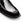 Close-up of a black leather loafer shoe showing the toe cap, side stitching, and textured sole on a white background.