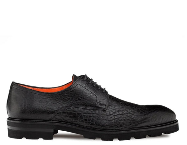 A single black textured leather oxford shoe with a thick lug sole and bright orange interior lining.