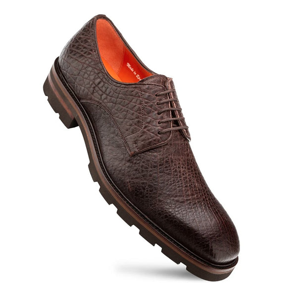 A dark brown textured leather shoe with a rugged lug sole and an orange interior lining.