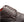 Close-up of a dark brown pebbled leather lace-up shoe on a white background.