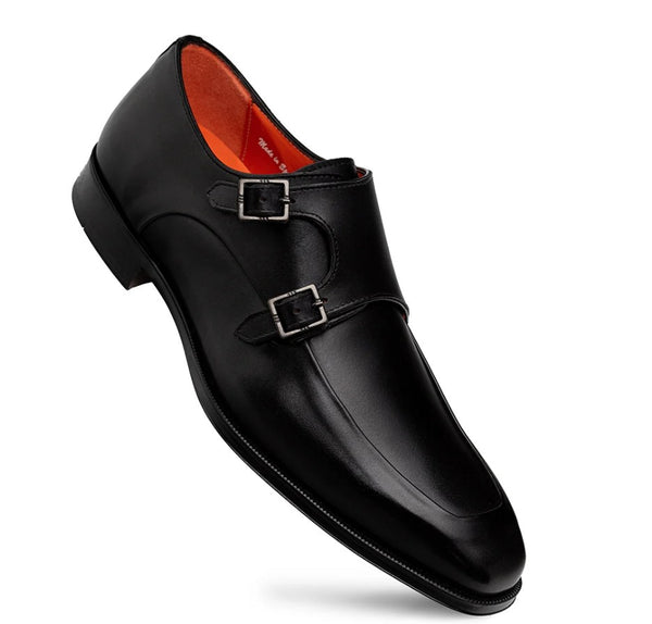 A single black leather double monk strap shoe with silver-tone buckle hardware and a bright orange interior lining, shown on a plain white background.