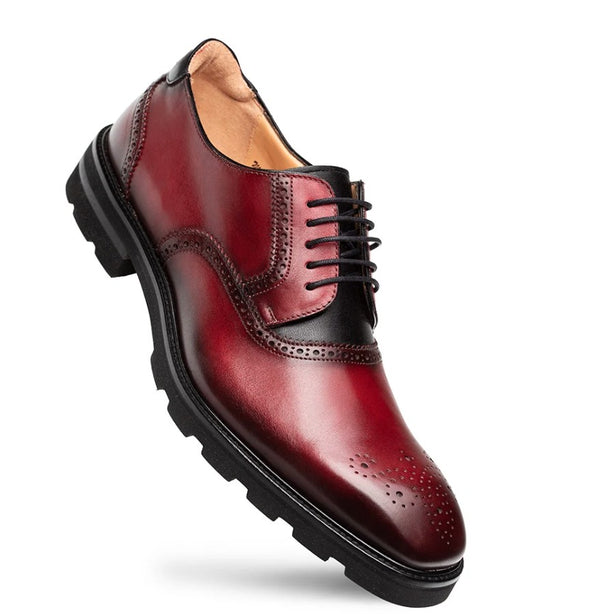 A men's wingtip oxford shoe in glossy burgundy red leather with black laces and a black sole.