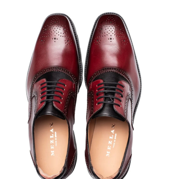 A pair of Mezlan men's oxford shoes in a deep burgundy and black colorway, shown from a top-down view on a white background.