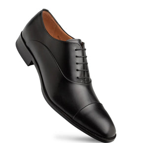 A classic black leather men's oxford dress shoe with a cap toe and black laces, shown from a three-quarters angle on a white background.