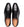 A pair of black leather dress shoes with a cap toe and laces, shown from a top-down view on a white background. The tan insole displays the brand name 'MEZLAN'.