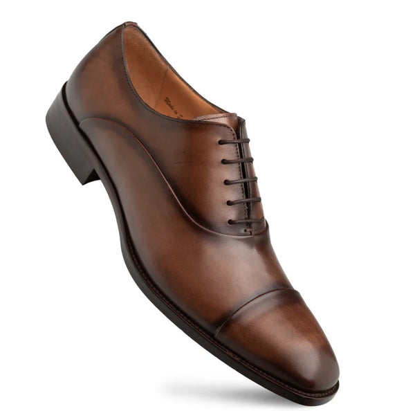A single men's brown leather oxford dress shoe with a cap toe and dark laces, shown at an angle on a plain white background.