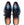 A pair of men's oxford dress shoes with a glossy dark blue and teal gradient finish, featuring brogue detailing on the toe and black laces, shown from a top-down view on a white background.