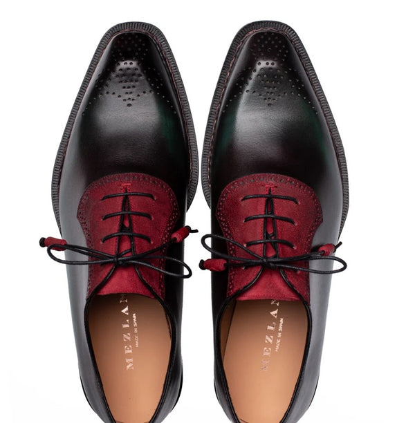 A pair of men's dress shoes shown from a top-down view, featuring a deep red suede vamp and black laces, on a white background.