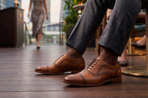 Man sitting with Brown leather shoes on