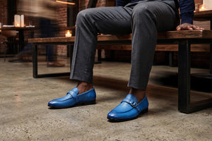 Man sitting on bench with blue loafers