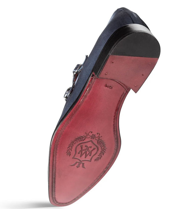 A single men's dress shoe shown from the sole side, featuring a reddish-brown leather sole with an embossed logo.