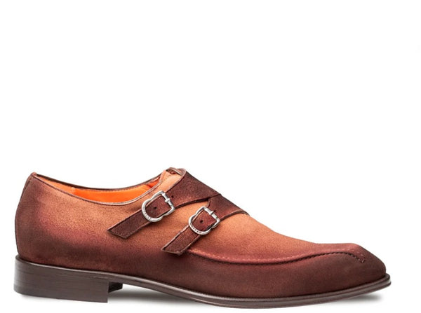 A single men's double strap monk-style shoe in brown suede, featuring silver-tone buckle details and a low stacked heel, shown against a plain white background.