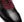 A close-up of a men's wingtip oxford shoe with a black brogue leather toe and black laces, transitioning into a deep burgundy red suede vamp on a white background.