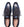 A pair of men's wingtip oxford shoes in navy blue and black brogue leather, shown from a top-down view on a white background. The brand name 'MEZLAN' is visible on the insoles.