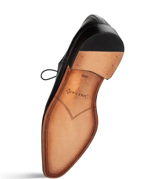 A single black leather dress shoe shown from the sole side, revealing a tan leather footbed with the brand name 'MEZLAN' printed on it, set against a plain white background.
