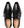 A pair of black leather dress shoes with pointed toes and black laces, shown from a top-down view on a white background. The insole is tan with the brand name 'MEZLAN' printed in gold.