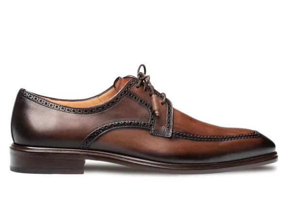 A classic men's brown leather oxford dress shoe with brogue detailing and a dark brown pointed toe, shown in a side profile on a white background.