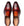 A pair of men's wingtip loafers in a rich two-tone brown leather photographed from a top-down angle on a white background.